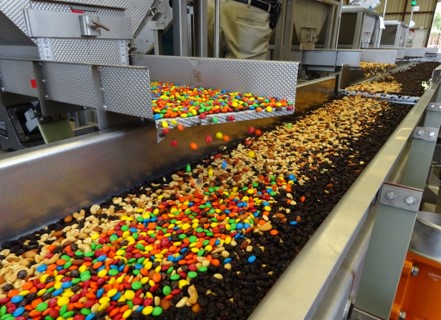 Candy is mixed, blended, and sorted on a vibratory conveyor
