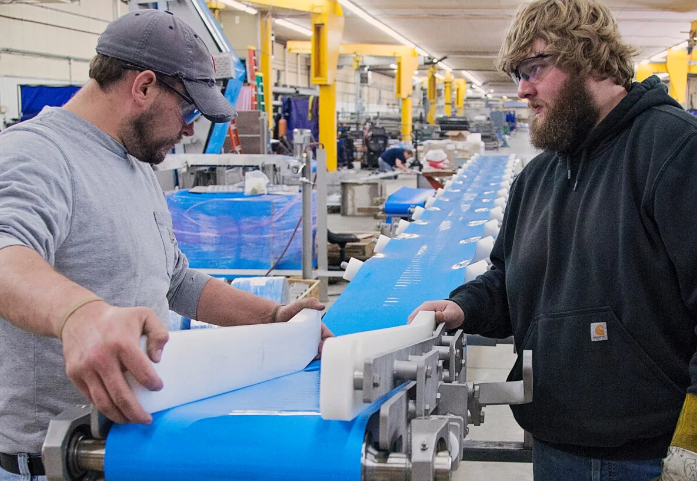 PFI engineers work on a meat processing conveyor solution.